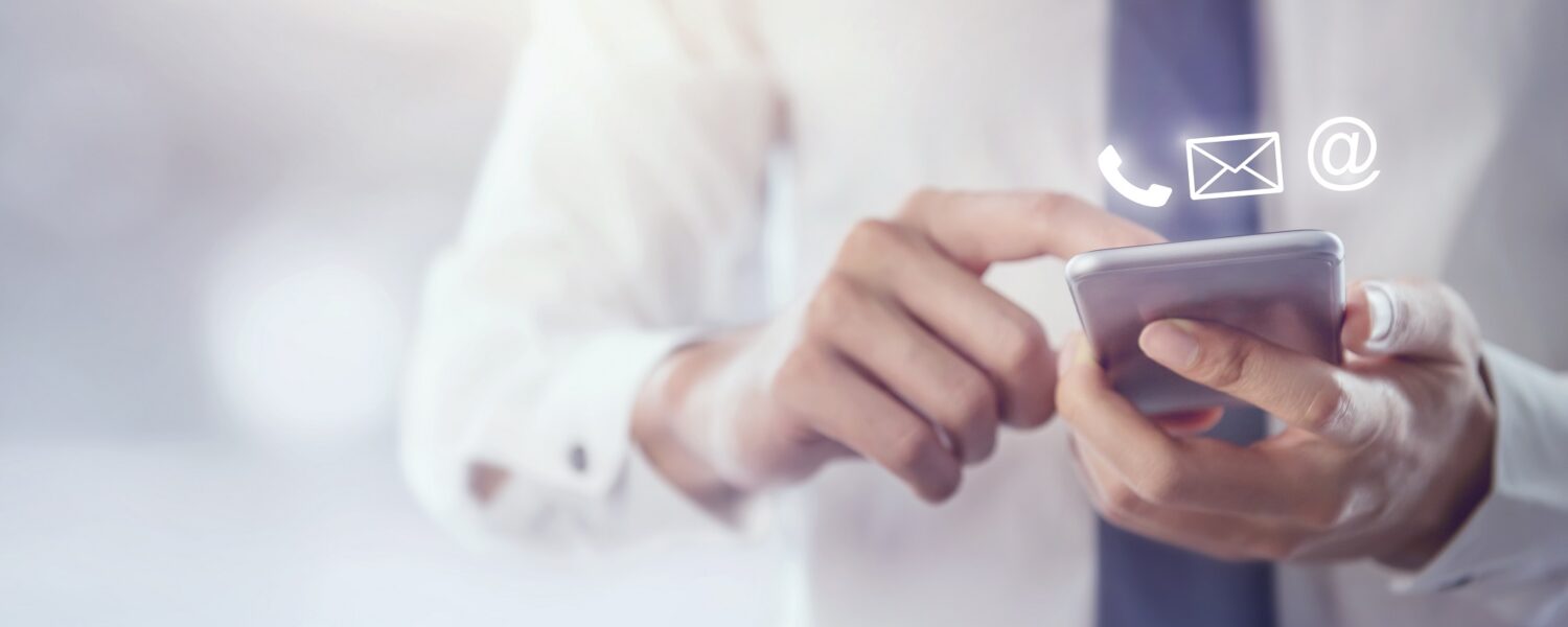 Contact,Us,,Hand,Of,Businessman,Holding,Mobile,Smartphone,With,(